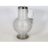 A silver topped commemorative smokers & drinkers water jug inscribed ER with English Rose design & d