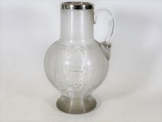A silver topped commemorative smokers & drinkers water jug inscribed ER with English Rose design & d