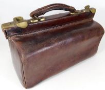A small leather Gladstone bag