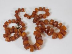 A Victorian amber necklace of irregular cylindrica