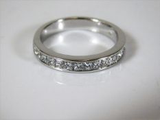 An 18ct white gold half eternity ring set with 1.1