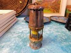 A small miners lamp, crack to glass