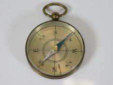 A vintage brass pocket compass