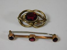 Two 19thC. yellow metal brooches set with garnet