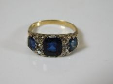 An 18ct gold ring set with blue glass stones & small diamonds 5.1g a/f