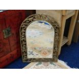 A arched gilt framed bevelled edge wall mirror