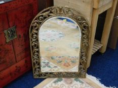 A arched gilt framed bevelled edge wall mirror