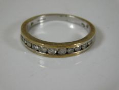A white metal ring marked 9k set with low grade di