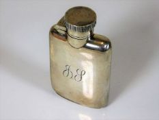 A small silver hip flask with initials to front