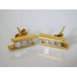 A pair of 18ct gold earrings set with 0.6ct diamon