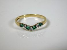A 9ct gold wishbone style ring set with emerald &