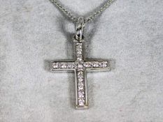 An 18ct white gold cross & chain set with 0.6ct di