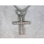 An 18ct white gold cross & chain set with 0.6ct di