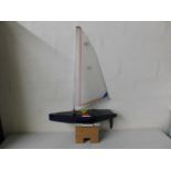 A remote control model yacht 28in long by 46in hig