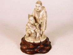 A Japanese Meiji period carved figure group with s