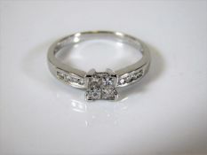 An 18ct white gold art deco style ring set with pr
