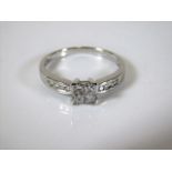 An 18ct white gold art deco style ring set with pr