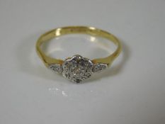 A 9ct gold ring of daisy form set with small diamo