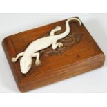 An early 20thC. cigarette case with ivory lizard