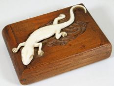 An early 20thC. cigarette case with ivory lizard
