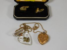 A pair of plated cuff links, a yellow metal locket