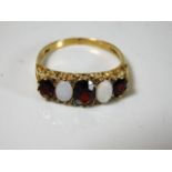 A 9ct gold garnet, opal ring set with small diamon