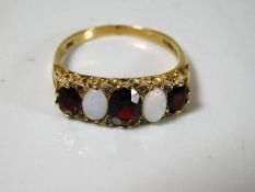 A 9ct gold garnet, opal ring set with small diamon