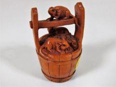 A carved wood netsuke depicting rats & in pail, si