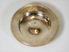 A silver trinket dish with pheasant design