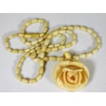 A Victorian ivory necklace with carved ivory rose
