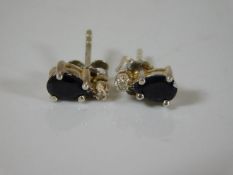 A pair of 9ct gold sapphire & gold earrings set wi