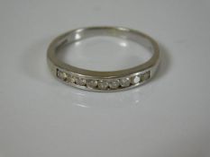 A 9ct half eternity white gold ring set with diamo