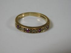 A 9ct gold half eternity ring set with ruby & diam