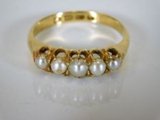 An 18ct gold ring set with five pearls 4.1g
