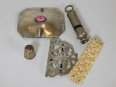 A silver thimble, an ivory brooch, a white metal b