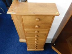 A bespoke hand made in Cornwall tall elm chest of nine drawers with sewing related contents