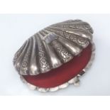 A lined scallop shell shaped French silver box with chased decor & inscribed shield