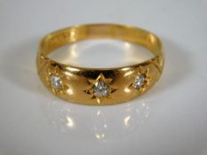 A 22ct gold ring set with three diamonds 3.6g