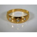 A 22ct gold ring set with three diamonds 3.6g