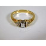 An 18ct art deco style emerald cut diamond ring 2.