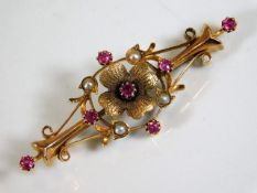 An antique 15ct gold brooch set with ruby & pearl