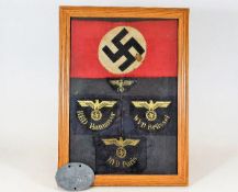 A German Third Reich Nazi framed selection of badg