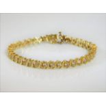 A 14ct gold & diamond line bracelet set with 4ct d