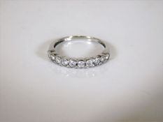 An 18ct white gold half eternity ring 2g set with