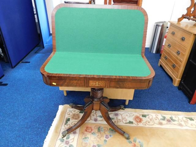 A mahogany Regency style card table with brass inl