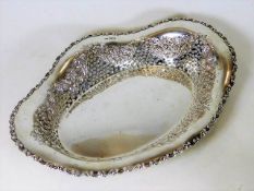 A silver bread basket with fretwork decor to sides