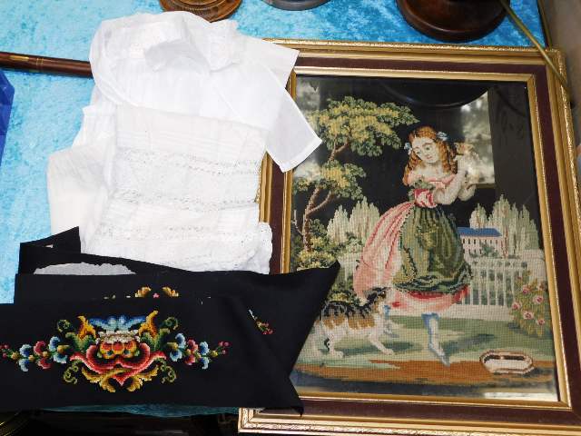 A framed needlework picture twinned with linen chr