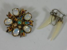 A moonstone brooch twinned with a pair of silver m