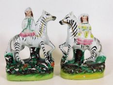 A pair of 19thC. Staffordshire zebras & riders 6.7