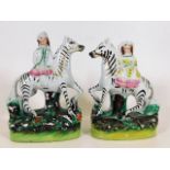 A pair of 19thC. Staffordshire zebras & riders 6.7